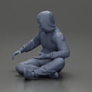 Contemplative man in hoodie sitting cross-legged, expressing curiosity thoughtfully - Only-Games