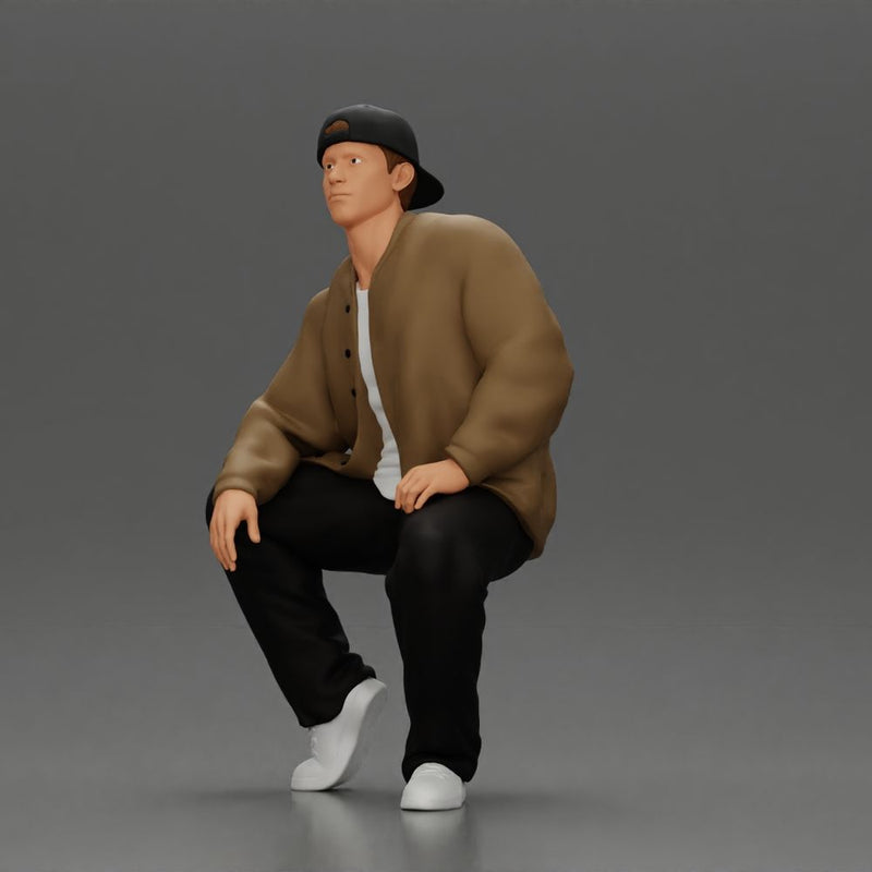 hip hop man sitting in a jacket and cap