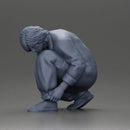 Worker injumpsuit Squatting Down, Carefully Adjusting His Pants with Focus - Only-Games