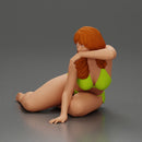 attractive girl in a bikini, lying and reclining gracefully on the beach - Only-Games
