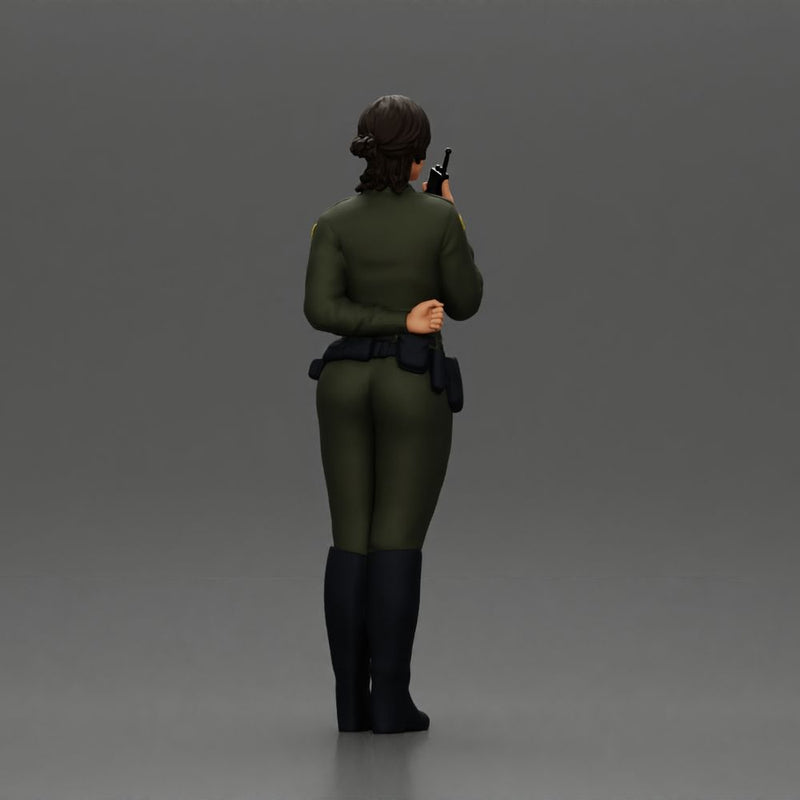 policewoman standing hand resting on her back speaking into a radio with short hair