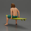 Long-Haired Surfer Sitting on a Surfboard in Calm Ocean Waters, Waiting for the Waves - Only-Games