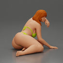 attractive girl in a bikini, lying and reclining gracefully on the beach - Only-Games