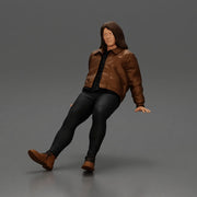 Man with long hair wearing brown jacket sitting with relaxed posture - Only-Games