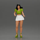 woman standing with a green top white skirt looking like they want to hold something - Only-Games