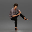 Man Sitting With Knee Bent In Shirt Trousers And Sandals