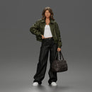 Confident Hand On Hip Poser Holding Bag Jacket Pants Sneakers