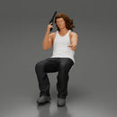 Man sitting with gun in hand pointing forward calmly - Only-Games