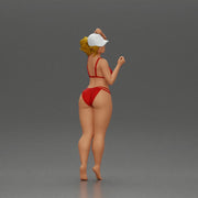 Stylish woman confidently posing in red bikini and white cap - Only-Games