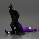 Batman dragging Joker by leg after defeating him in battle - Only-Games
