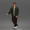 Man standing In Bomber Jacket Tee Trousers Sneakers And Sunglasses