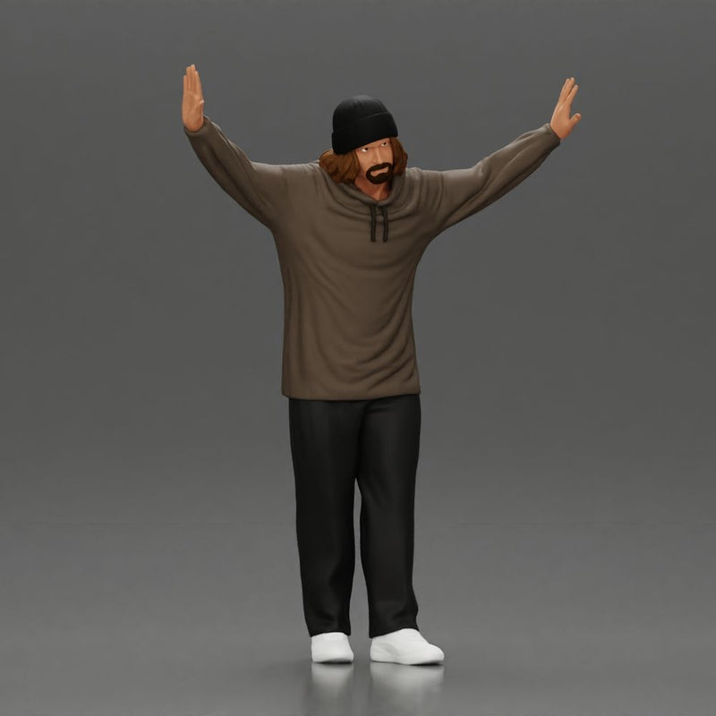 Man wearing hoodie and beanie raises hands looking happy in relaxed stance - Only-Games
