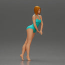 woman in a turquoise swimsuit striking a pose - Only-Games