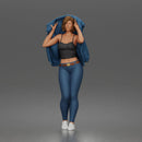 Woman Putting On Jacket Over Crop Tank And Leggings With Sneakers
