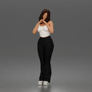 Thoughtful woman stands daydreaming wearing crop tank top and trousers - Only-Games