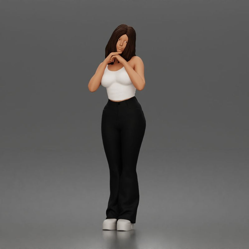 Thoughtful woman stands daydreaming wearing crop tank top and trousers - Only-Games