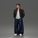 Urban male standing in varsity jacket and baggy trousers