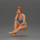 Woman sitting in Blue Bikini Ponders with Relaxed Posture - Only-Games
