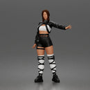 Woman Posing With Arm Extended In Crop Jacket Bralette Leather Shorts And Strappy Boots