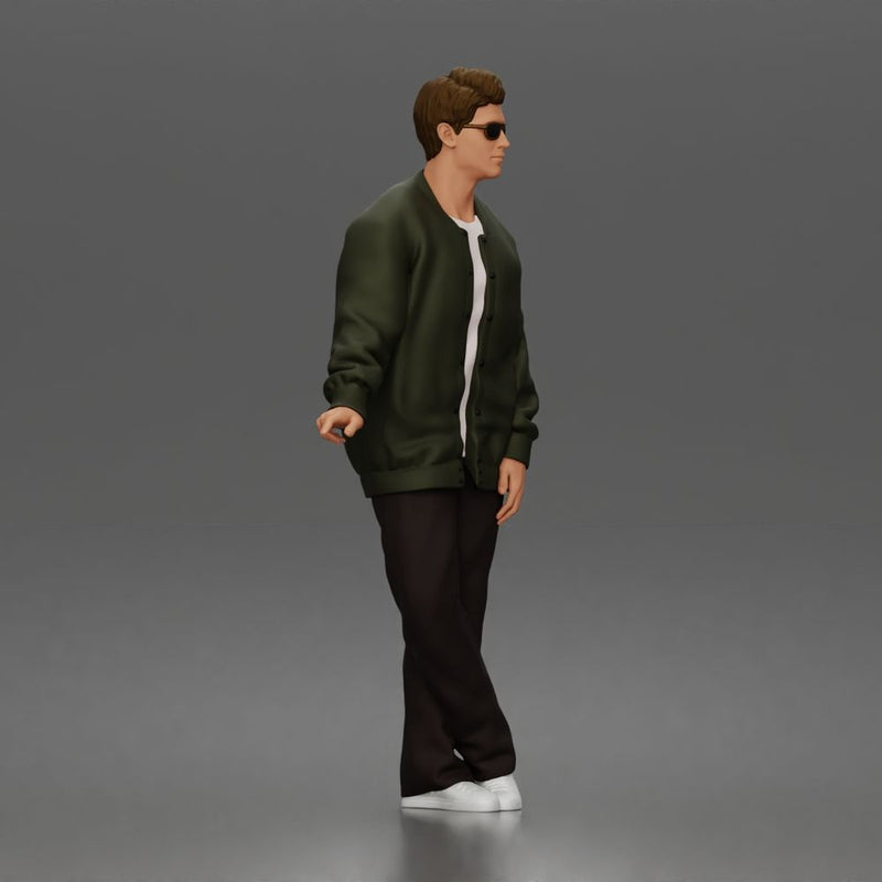 Man standing In Bomber Jacket Tee Trousers Sneakers And Sunglasses