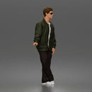 Man standing In Bomber Jacket Tee Trousers Sneakers And Sunglasses