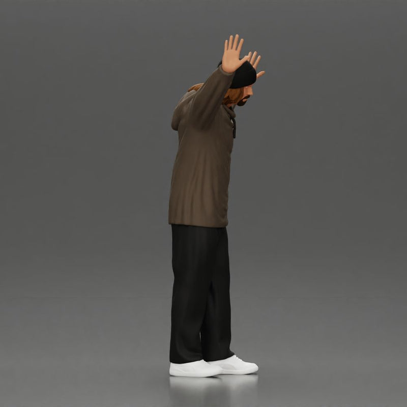 Man wearing hoodie and beanie raises hands looking happy in relaxed stance - Only-Games