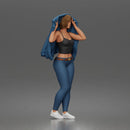 Woman Putting On Jacket Over Crop Tank And Leggings With Sneakers
