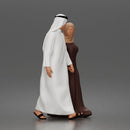 Walking man wearing thobe holding hands with woman wearing abaya