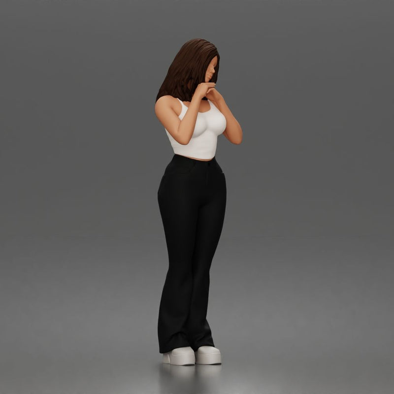 Thoughtful woman stands daydreaming wearing crop tank top and trousers - Only-Games