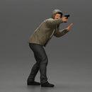 Man in hoodie pointing gun while raising hand in defensive gesture - Only-Games