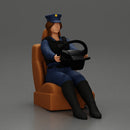 Focused officer in blue uniform driving seated holding steering wheel - Only-Games