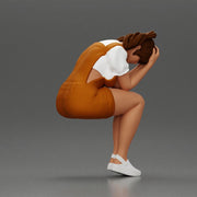 Crying girl sitting low in orange dress with head in hands - Only-Games