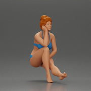 Woman sitting in Blue Bikini Ponders with Relaxed Posture - Only-Games