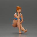 Woman sitting in Blue Bikini Ponders with Relaxed Posture - Only-Games