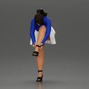 Young woman in skirt adjusts her elegant black high heeled shoes - Only-Games