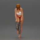 Woman in white top carefully wearing grey pants with balance - Only-Games