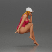 Woman in Swimsuit and Cap Sitting Thoughtfully in Relaxed Pose - Only-Games