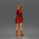 Cheerful Girl Waving Confidently in Stylish Dress and Boots