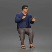 Asian Man sits gesturing while wearing casual sweater pants flip flops comfortably - Only-Games