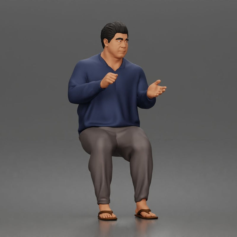 Asian Man sits gesturing while wearing casual sweater pants flip flops comfortably - Only-Games