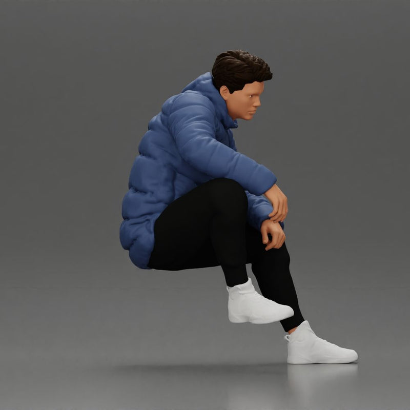 Street performer crouching low in blue puffer jacket athletic stance sitting - Only-Games