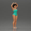 Brunette woman in turquoise swimsuit stretching with elegant ballet pose - Only-Games