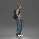 Student standing with backpack wearing oversized tee and baggy jeans