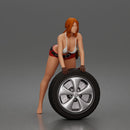 woman Pushing Tire In Bikini Top Shorts Tool Belt And Gloves