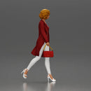 Woman with curly hair wearing red coat walking holding red handbag - Only-Games
