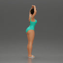 Brunette woman in turquoise swimsuit stretching with elegant ballet pose - Only-Games