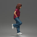 Girl Leaning posing against wall in pocket tee and denim