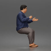 Asian Man sits gesturing while wearing casual sweater pants flip flops comfortably - Only-Games