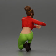 Fashionable woman kneeling in red jacket, green pants, and black boots - Only-Games