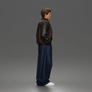 Urban male standing in varsity jacket and baggy trousers